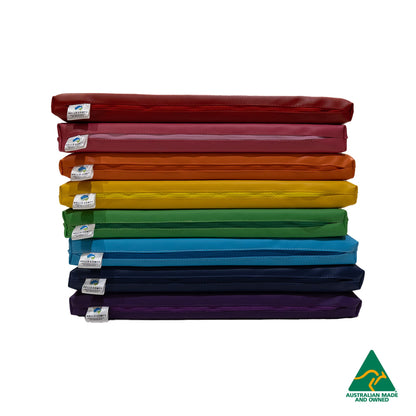 Stack of Red, Pink, Orange, yellow, Green, Blue, Navy and Purple Hello Comfy Child Care Sleep Mats made from waterproof PVC vinyl and foam, tested to AS/NZS 8811.1:2013, Australian-made for daycare and child care use