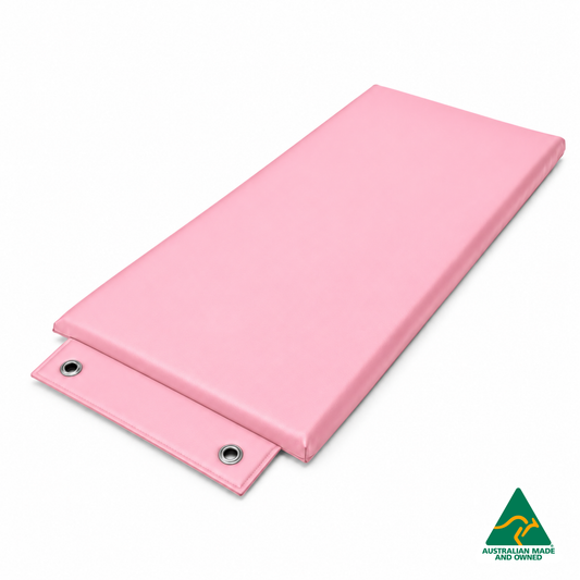 Angled view of the Baby Pink Hello Comfy Hanging Child Care Sleep Mat with two reinforced eyelets, waterproof vinyl and foam tested to AS/NZS 8811.1:2013, Australian-made for child care, kindergarten, school and daycare use.