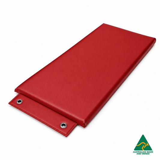 Angled view of the Red Hello Comfy Hanging Child Care Sleep Mat with two reinforced eyelets, waterproof vinyl and foam tested to AS/NZS 8811.1:2013, Australian-made for child care, kindergarten, school and daycare use.